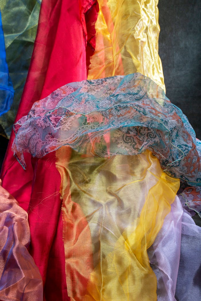 Vibrant silk fabrics in various colors and patterns showcase texture and artistry.