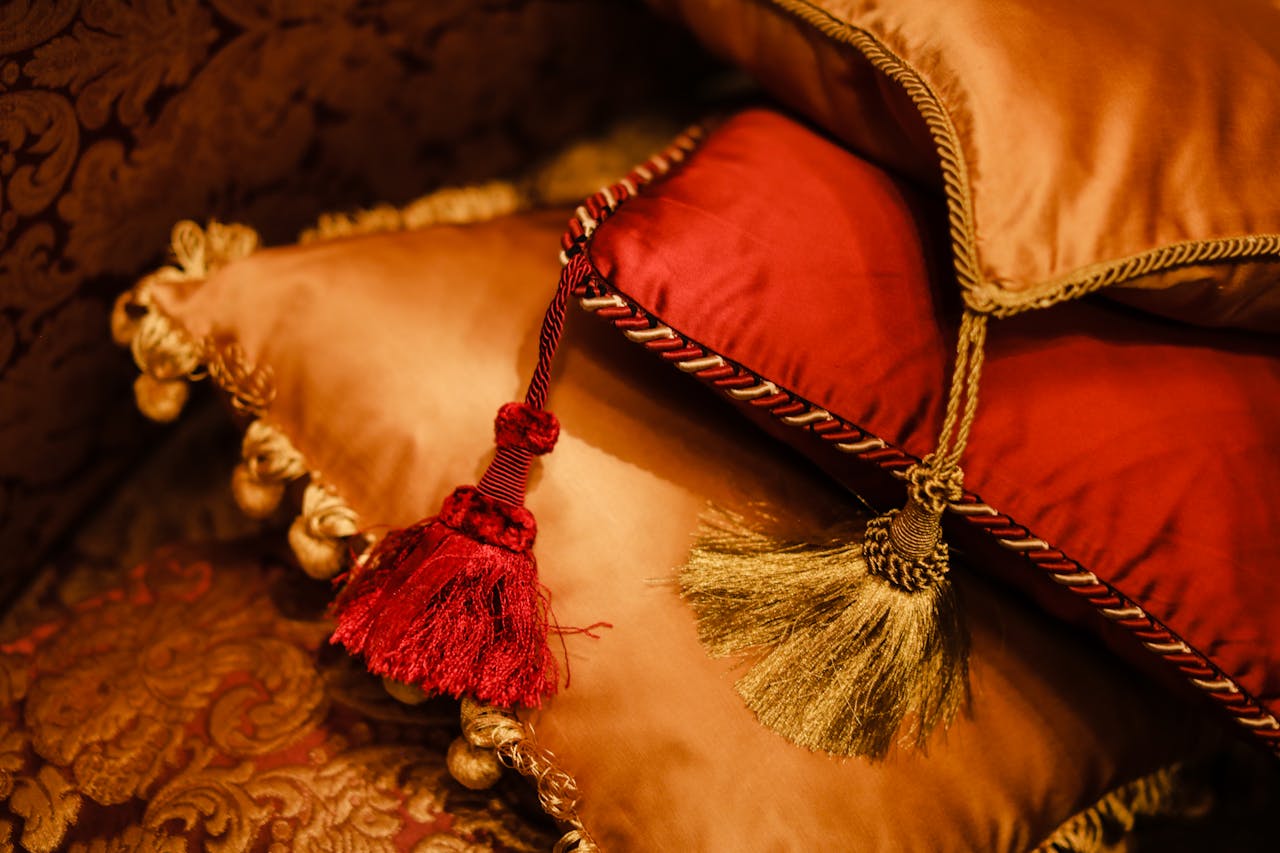 gallery-6 Elegant velvet cushions with decorative tassels add a touch of luxury to any interior space.